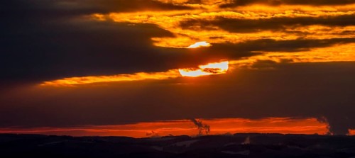 Aerial view of the sunset with a view over the snowy winter landscape from Winterberg to the