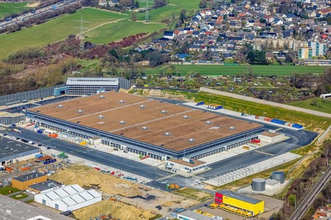 Aerial view, construction site new building Amazon logistics centre, industrial estate on