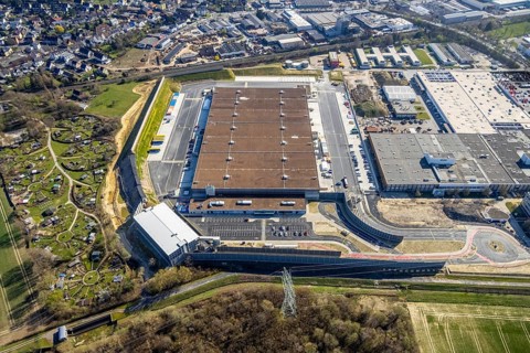Aerial view, construction site new building Amazon logistics centre, industrial estate on