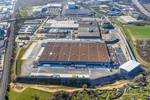 Aerial view, construction site new building Amazon logistics centre, industrial estate on