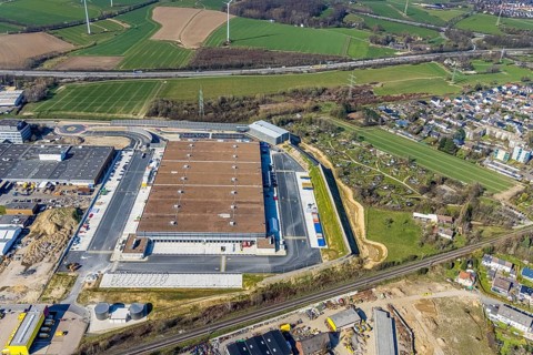 Aerial view, construction site new building Amazon logistics centre, industrial estate on