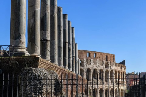 View past columns of Temple of Venus Temple of Venus on facade of upper tiers of Colosseum, Rome,