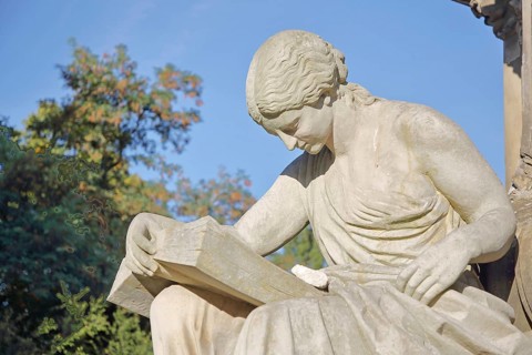 Seated white female figure reading a thick book as a symbol of science, allegory, knowledge,