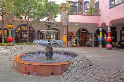 Inner courtyard with fountain and colourful columns, Green Citadel, Hundertwasser House, Magdeburg,