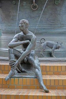 Detail with naked seated male figure and dog figure peeing at the Faun Fountain by Heinrich Apel