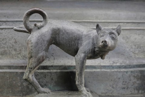 Detail with dog figure urinating at the Faun Fountain by Heinrich Apel 1986, holding one leg up,