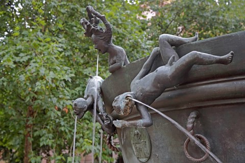 Detail with naked male figures hanging upside down on the edge of the water basin at the Faun