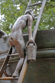 Detail with male figure with bucket climbing up a rung ladder at the Faun Fountain by Heinrich Apel