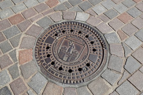 Manhole cover with city coat of arms, paving stones, floor, inscription, Magdeburg, Saxony-Anhalt,