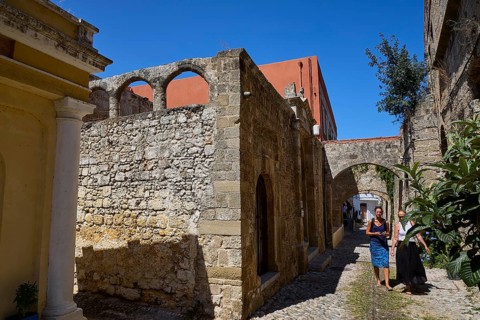 Narrow alley in an old town with two people and old buildings, Kahal Shalom Synagogue, Sephardic