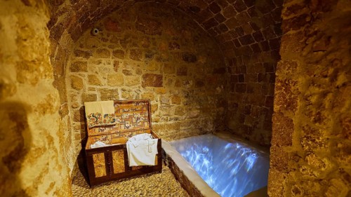 A stone room with an illuminated immersion bath for ritual purification, Kahal Shalom Synagogue,