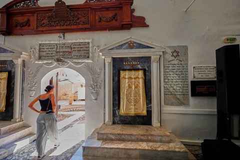 A woman enters a synagogue through a decorative arch, Kahal Shalom Synagogue, Sephardic Synagogue,