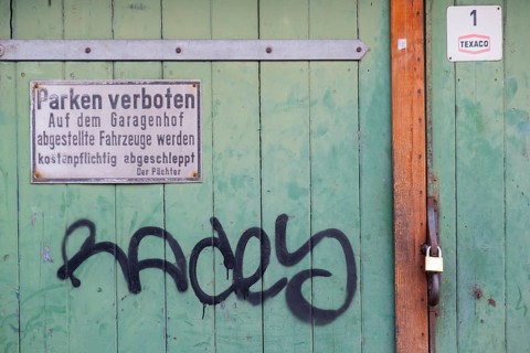 Photograph of a no parking sign attached to a wooden garage door, Hanover, Lower Saxony, Germany