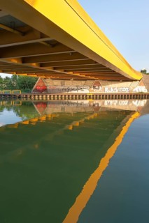 View across the Mittelland Canal to the underside and the graffiti-painted abutment of a bridge on