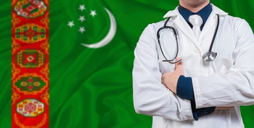 Male doctor with stethoscope on Turkmen flag. Doctor holding stethoscope on Turkmenistan flag