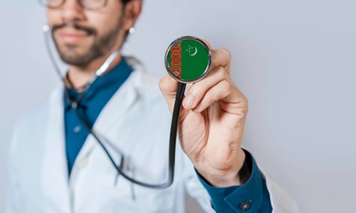 Doctor holding stethoscope with Turkmenistan flag. Turkmenistan health and care concept,