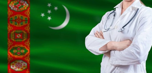 Doctor with crossed arms on Turkmenistan flag. Turkmen health and care concept. Female doctor on