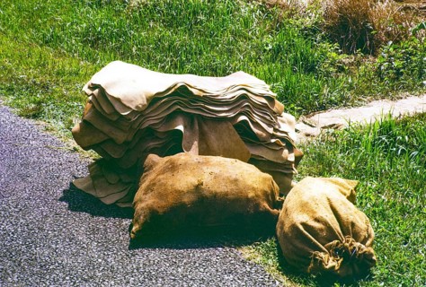 Unsmoked sheets and sacks of rubber piled up on roadside, Malaya, Malaysia, south east Asia 1963
