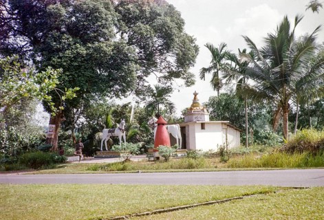 Statues of large white horses stand outside Kutherai kovil unregistered Hindu temple shrine,