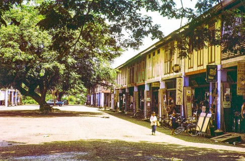Row of Chinese shophouses businesses in building, unspecified location in Malaya, Malaysia, south