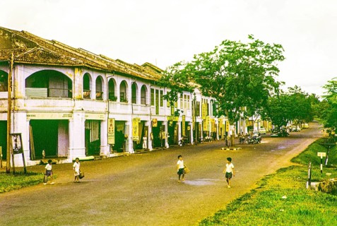 Row of Chinese shophouses businesses in building, unspecified location in Malaya, Malaysia, south