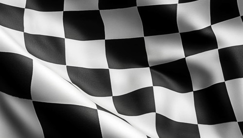 Black And White Checkered Flag Used In Racing Events To Signal The End Of A Race Or A Warning.