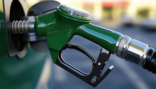 Green Gas Pump Spilling Fuel In A Fast Flow, Causing A Messy Situation At The Gas Station. Spillage