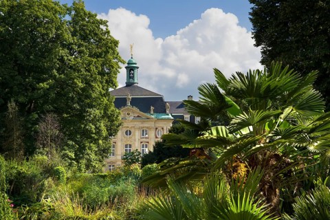 View from the exotical jungle of the botanical garden to the Prince Bishop's Castle,