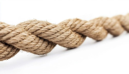 Detailed Close-Up Shot Of A Taut Rope Against A White Background Showing Strain And Pressure. High