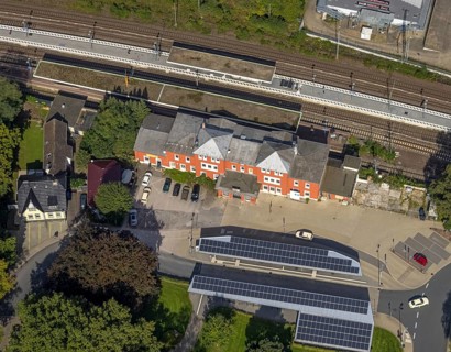 Aerial view, Schwelm railway station with red station building and bus station with solar roof in