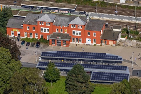 Aerial view, Schwelm railway station with red station building and bus station with solar roof in