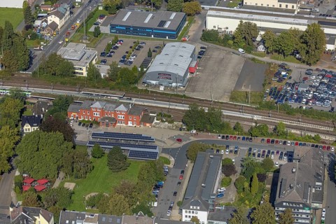 Aerial view, Schwelm railway station with red station building and bus station with solar roof and