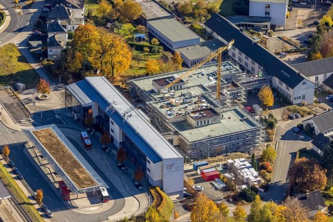Aerial view, bus station and construction work at the vocational college Olsberg of the HSK in