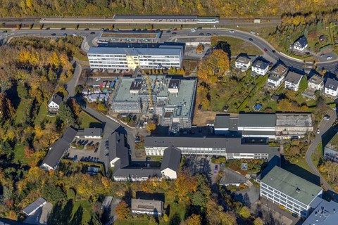Aerial view, bus station and construction work at the vocational college Olsberg of the HSK in