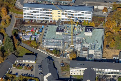 Aerial view, bus station and construction work at the vocational college Olsberg of the HSK in