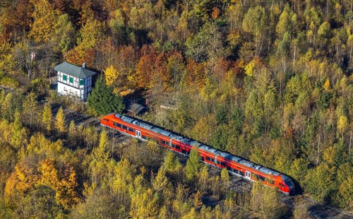 Aerial view, S-Bahn at a guard house in autumn forest in the district of Bigge in Olsberg,
