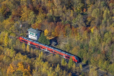 Aerial view, S-Bahn at a guard house in autumn forest in the district of Bigge in Olsberg,