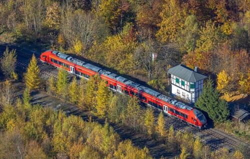 Aerial view, S-Bahn at a guard house in autumn forest in the district of Bigge in Olsberg,