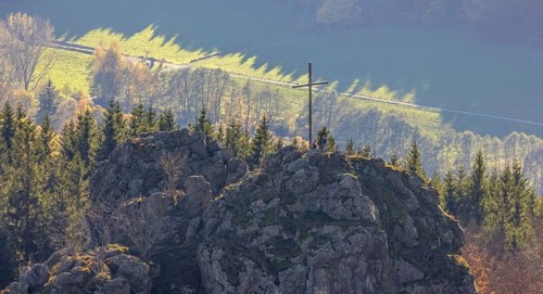 Aerial view, autumn forest and Bruchhauser Steine with summit cross in the district Bruchhausen in