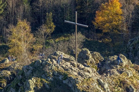 Aerial view, autumn forest and Bruchhauser Steine with summit cross in the district Bruchhausen in