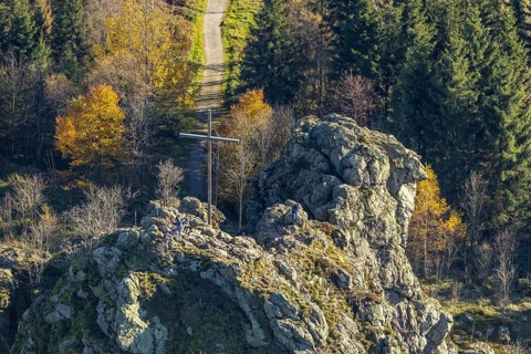 Aerial view, autumn forest and Bruchhauser Steine with summit cross in the district Bruchhausen in
