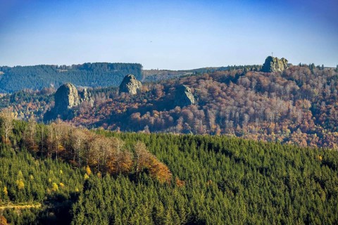 Aerial view, autumn forest and Bruchhauser Steine with summit cross in the district Bruchhausen in