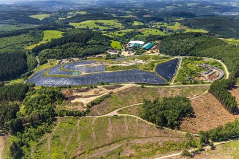 Aerial view, forest area with forest damage and clear cutting, area covered with plastic tarpaulins