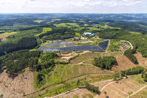 Aerial view, forest area with forest damage and clear cutting, area covered with plastic tarpaulins