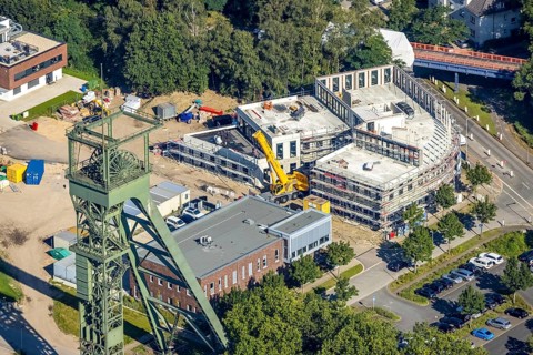 Aerial view, winding tower and Steigerhaus as well as construction site and new building at