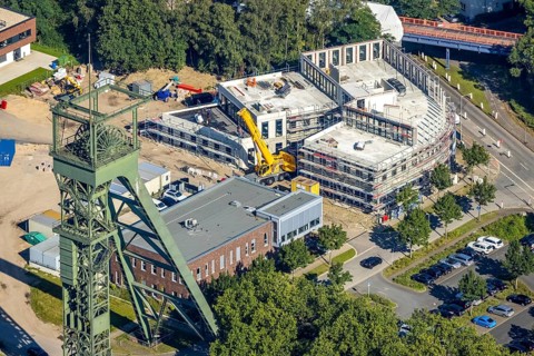 Aerial view, winding tower and Steigerhaus as well as construction site and new building at