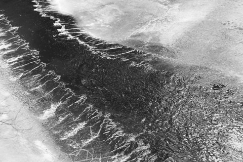 Black and white photograph of a flowing river with moving water, Kamptal Waldviertel Lower Austria