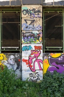 Graffiti with the pink panther on a wall-covered urban scene, Am Donaukanal Innere Stadt Vienna
