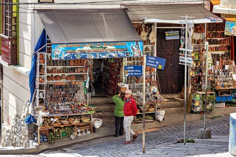 A busy market stall with souvenirs and signs in a lively street scene, The witches' market of La
