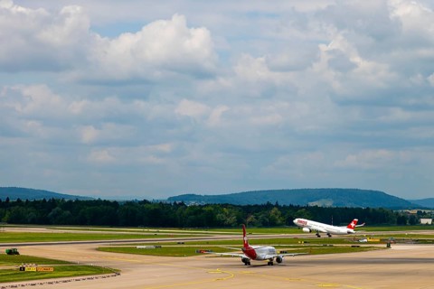 Swiss Airlines Passenger Airplane Take Off From the Runway and Flying Against Blue Sky and Clouds